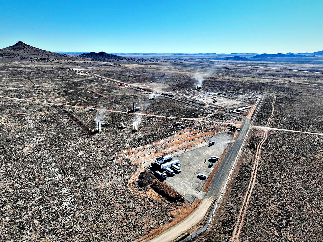 Aerial view of drilling rigs installing pile foundations at the Mooiplaats solar PV site