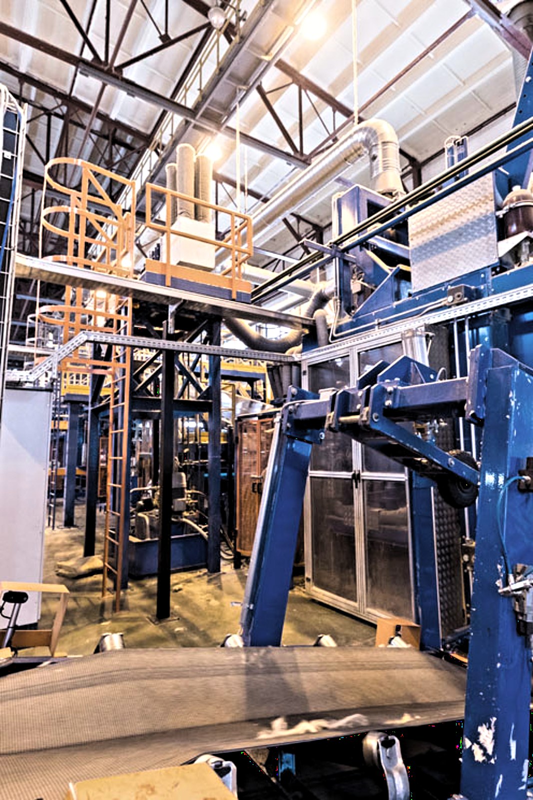Conveyor and steel structure inside an industrial processing plant
