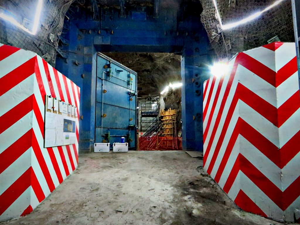 Underground shaft area with red and white hazard-marked walls